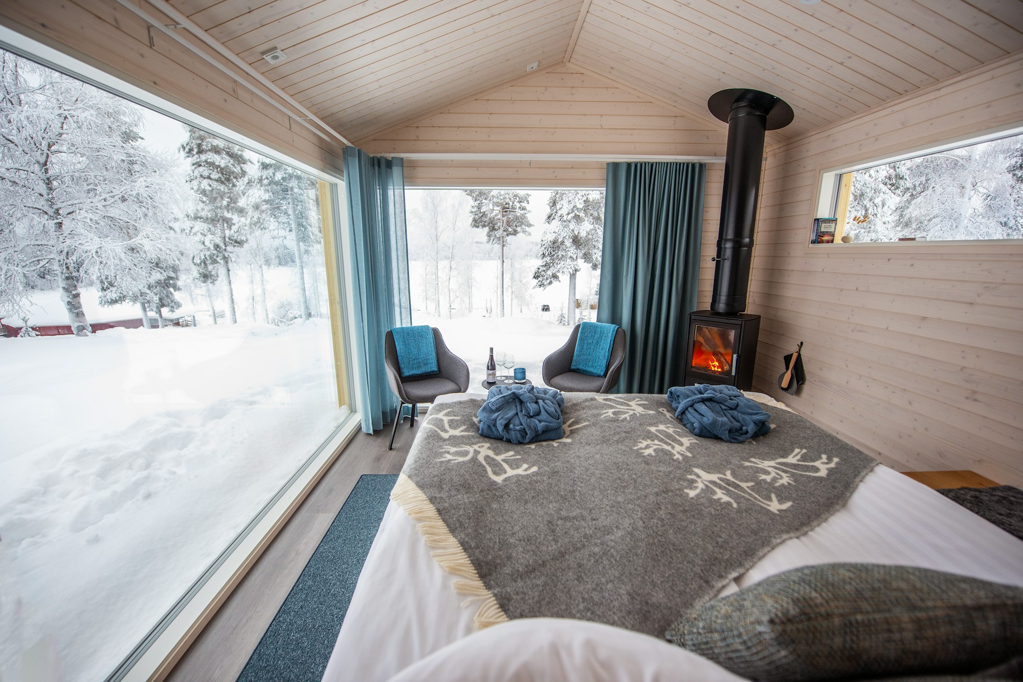 Lakeside cabin interior with panoramic snow view